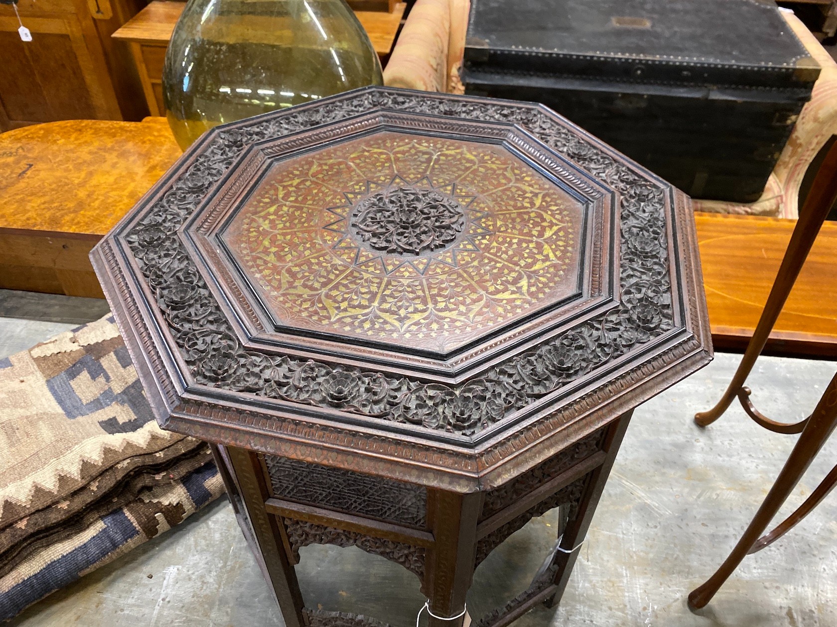 An Indian brass inlaid carved hardwood octagonal topped occasional table, width 62cm, height 62cm